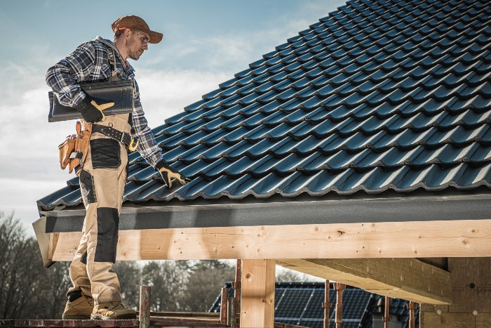 Roofing experts from Cunningham Contracting, Inc. working on a house roof in Baltimore County